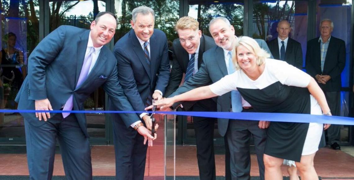 Lt. Gov. Dan Forest, second from left, and Greg Lindberg, third from left, participate in a ribbon-cutting ceremony in September 2017 for the new headquarters of Durham-based Global Bankers Insurance Group.