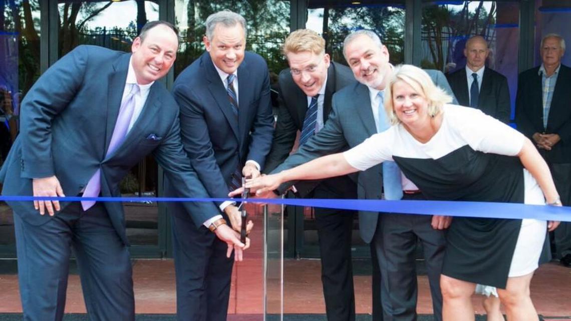 Lt. Gov. Dan Forest, second from left, and Greg Lindberg, third from left, participate in a ribbon-cutting ceremony in September 2017 for the new headquarters of Durham-based Global Bankers Insurance Group.
