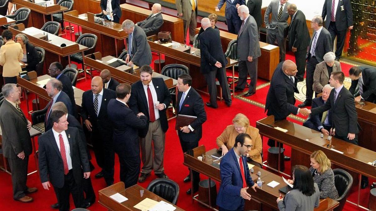 Members of the N.C. House of Representatives, mostly men, socialize on the floor before the N.C. General Assembly convenes at the Legislative Building in Raleigh, NC, on Jan. 25, 2017.