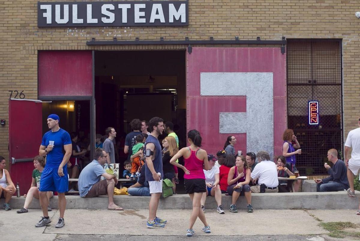 Fullsteam Brewery on Rigsbee Avenue in Durham is bustling with activity following its weekly run club gathering Sept. 25, 2013.