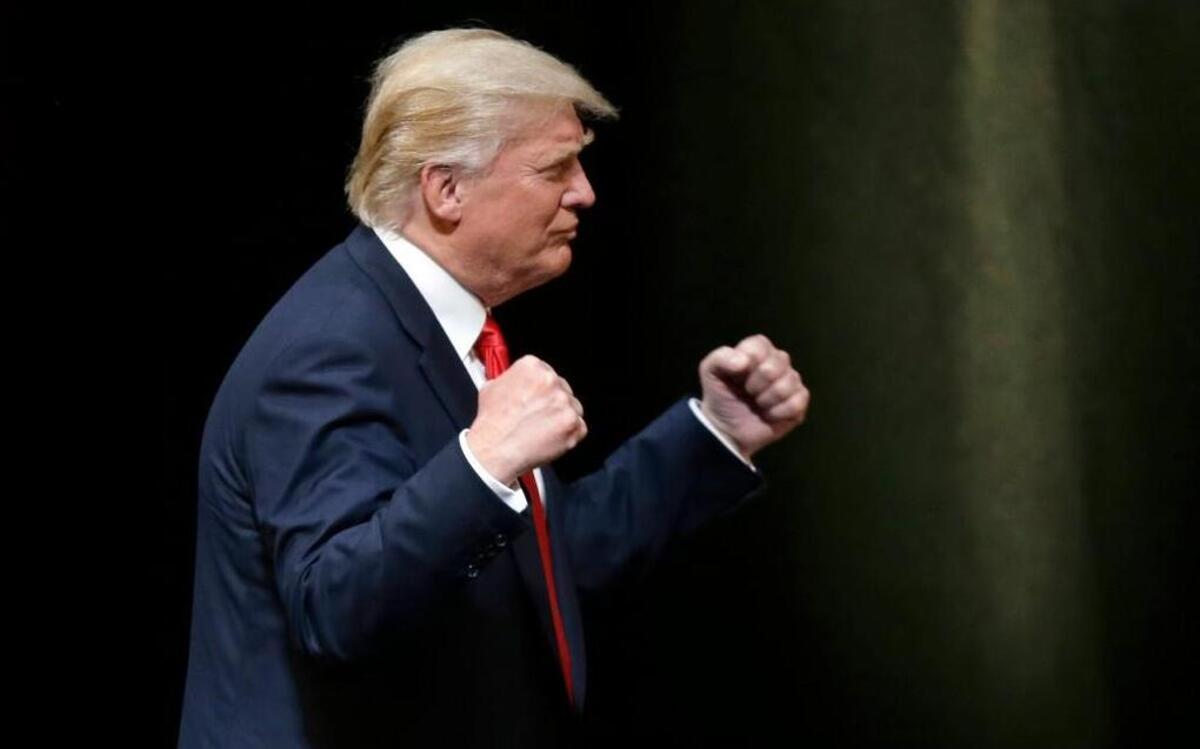 Republican Presidential candidate Donald Trump pumps his fists during a rally in Raleigh, N.C., Tuesday, July 5, 2016.