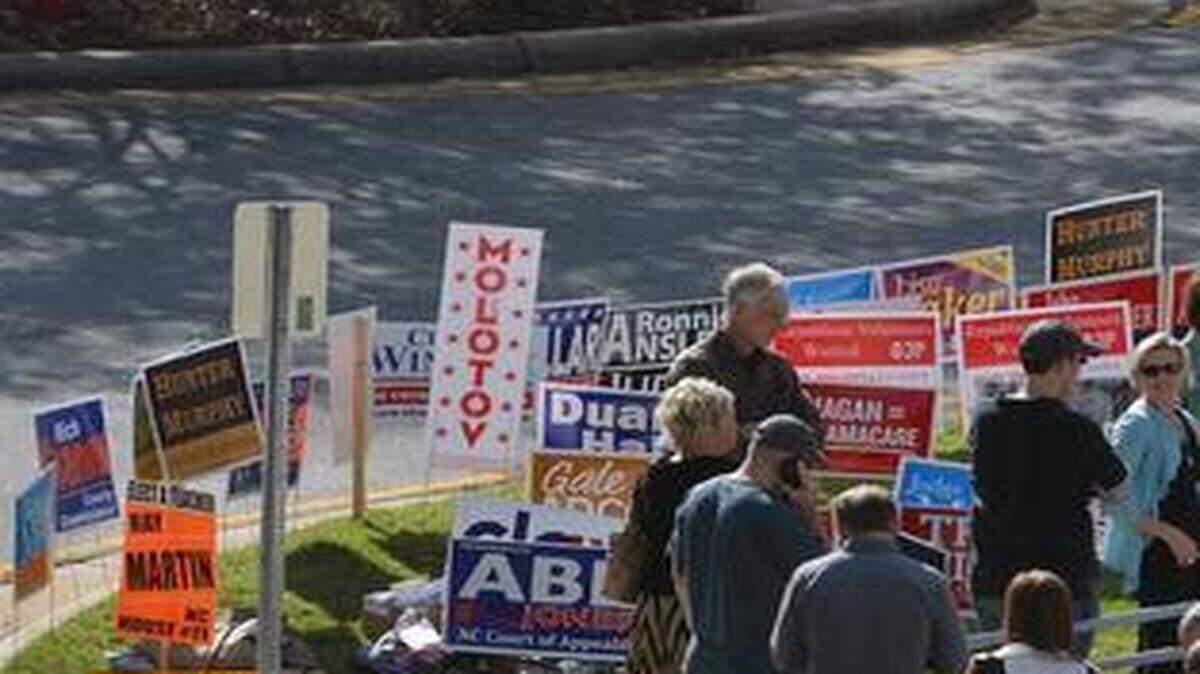 
Early voters crowd the sidewalk at Cary's Herb Young Community Center on Thursday, October 30, 2014.
