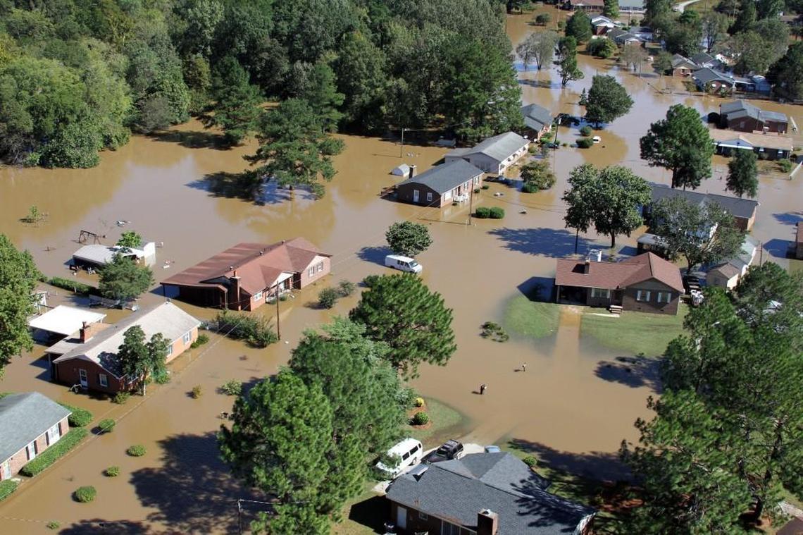 Flood waters surround several houses in Rocky Mount, N.C. near the Tar River Monday afternoon, Oct. 10, 2016. Heavy rains from Hurricane Matthew casued extensive flooding in eastern North Carolina.