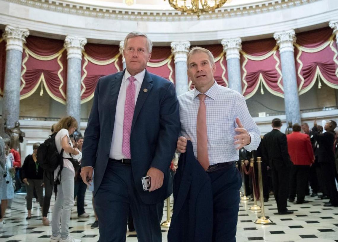 Rep. Mark Meadows, R-N.C., chairman of the conservative House Freedom Caucus, and Rep. Jim Jordan, R-Ohio, a key member of the group, walk through Statuary Hall at the Capitol in Washington, Wednesday, Sept. 13, 2017.