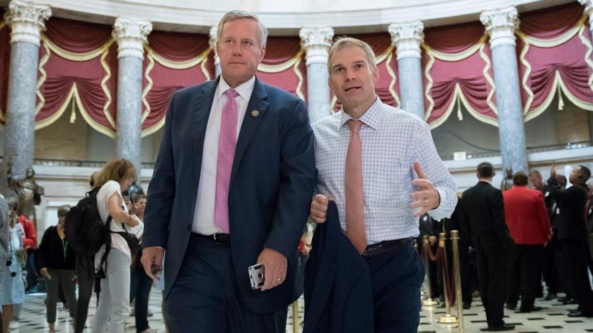 Rep. Mark Meadows, R-N.C., chairman of the conservative House Freedom Caucus, and Rep. Jim Jordan, R-Ohio, a key member of the group, walk through Statuary Hall at the Capitol in Washington, Wednesday, Sept. 13, 2017.