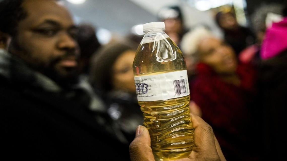 Pastor David Bullock holds up a bottle of Flint water at a protest outside Michigan Gov. Rick Snyder's office on Jan. 14, 2016.