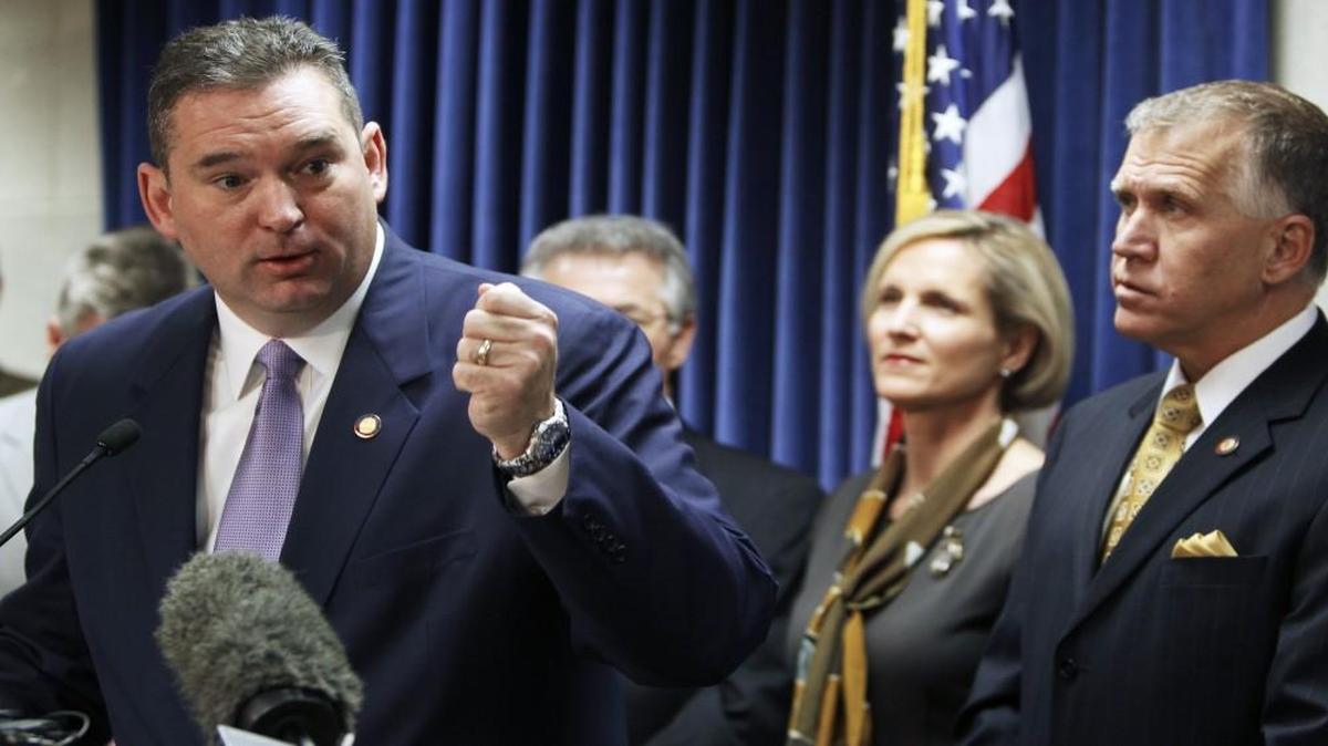 Rep. David Lewis, left, seen here at a 2013 news conference, took steps to help a friend and campaign donor keep his state contract by adding a provision to the final bill of this year’s legislative session.