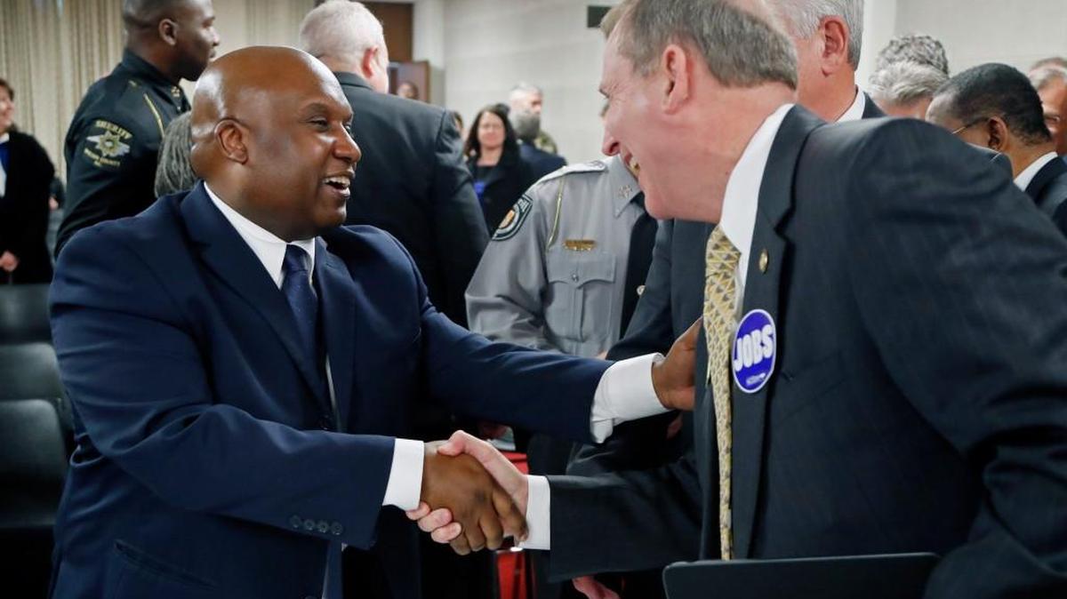 Erik Hooks, left, secretary of the Department of Public Safety, is congratulated by Republican Sen. Harry Brown after he was recommended for the position by a Senate committee at the Legislative Building in Raleigh on March 15, 2017.