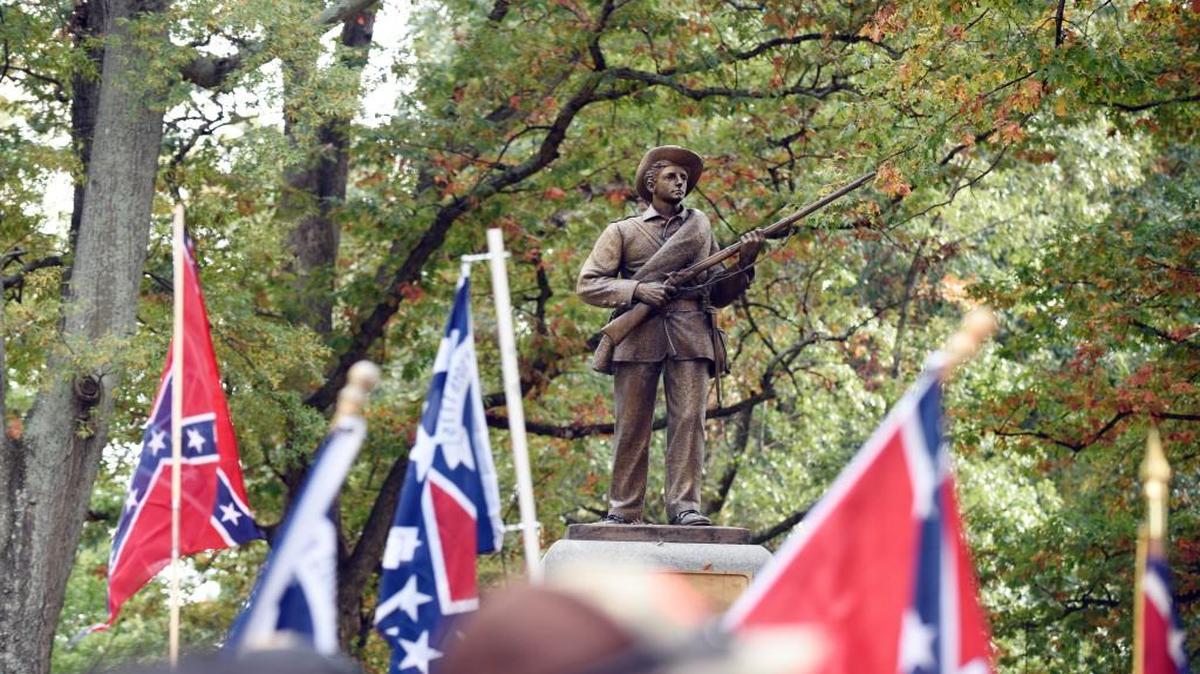 Confederate flags frame the confederate soldier monument known as "Silent Sam" during a rally on UNC campus in Chapel Hill, N.C. on Sunday, October 25, 2015.