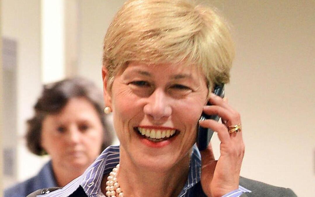 State Rep. Deborah Ross speaks on the phone as she leaves a committee meeting in 2013.