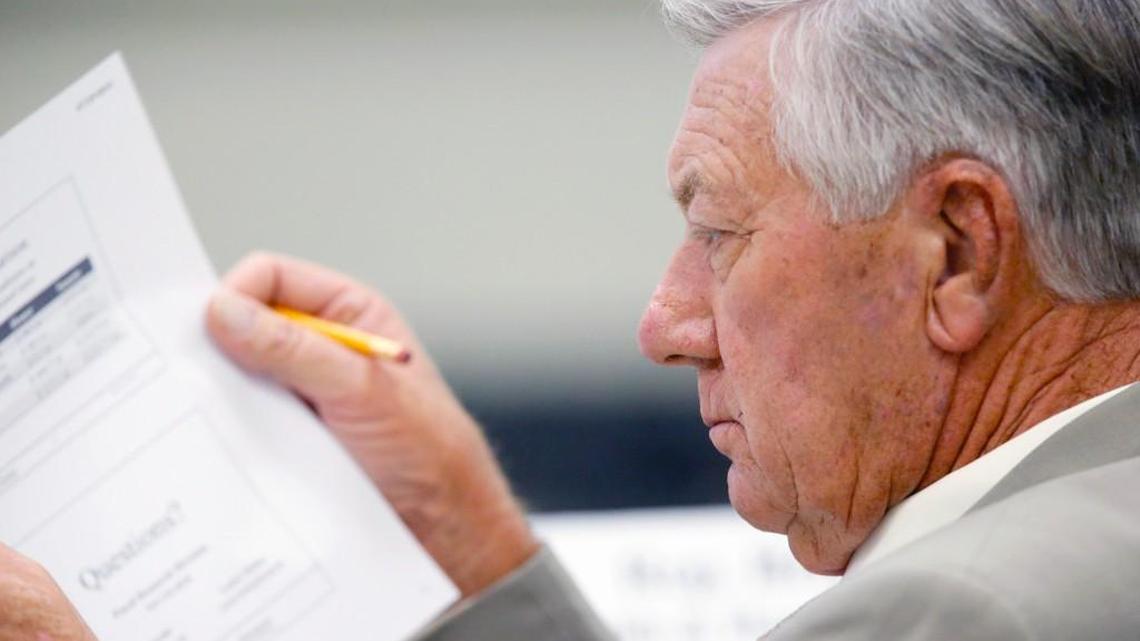 Rep. William Brisson reads over some material during a House Appropriations Committee meeting in Raleigh on July 29, 2015.