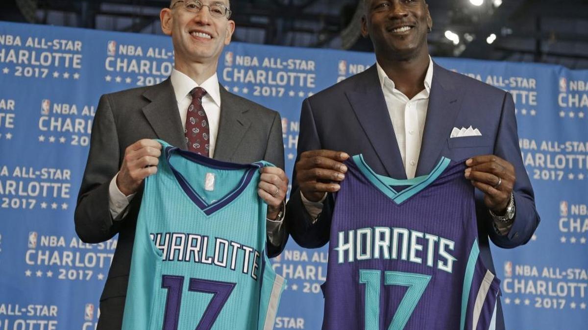 NBA commissioner Adam Silver, left, and Charlotte Hornets owner Michael Jordan, right, pose for a photo during a news conference to announce Charlotte, N.C., as the site of the 2017 NBA All-Star basketball game June 23, 2015.