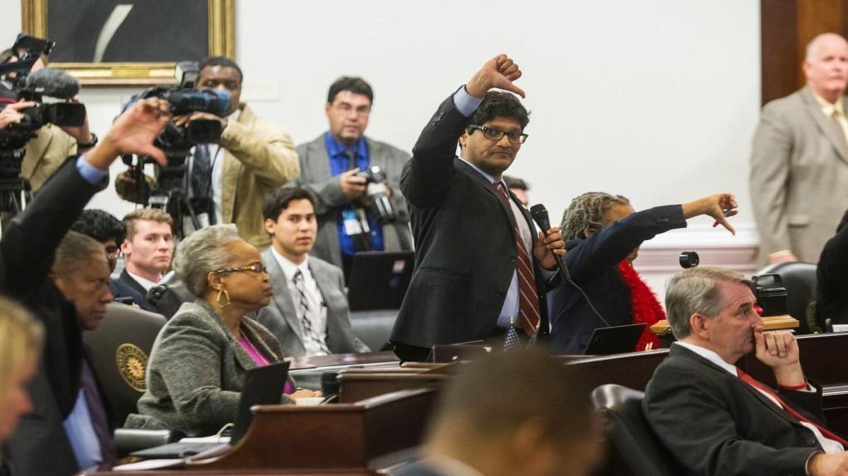 Democratic senators including Jay J. Chaudhuri, a Raleigh Democrat, center, vote not to table an amendment to Senate Bill 4 during the North Carolina General Assembly's fifth special session Wednesday, December 21, 2016, in the Senate chambers.