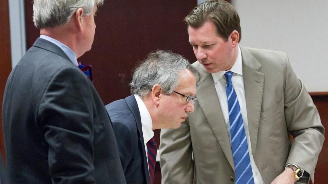 Thomas Farr, center, conferring with attorneys during a break at a hearing to determine whether the Voter ID law requires a change to the N.C. Constitution.