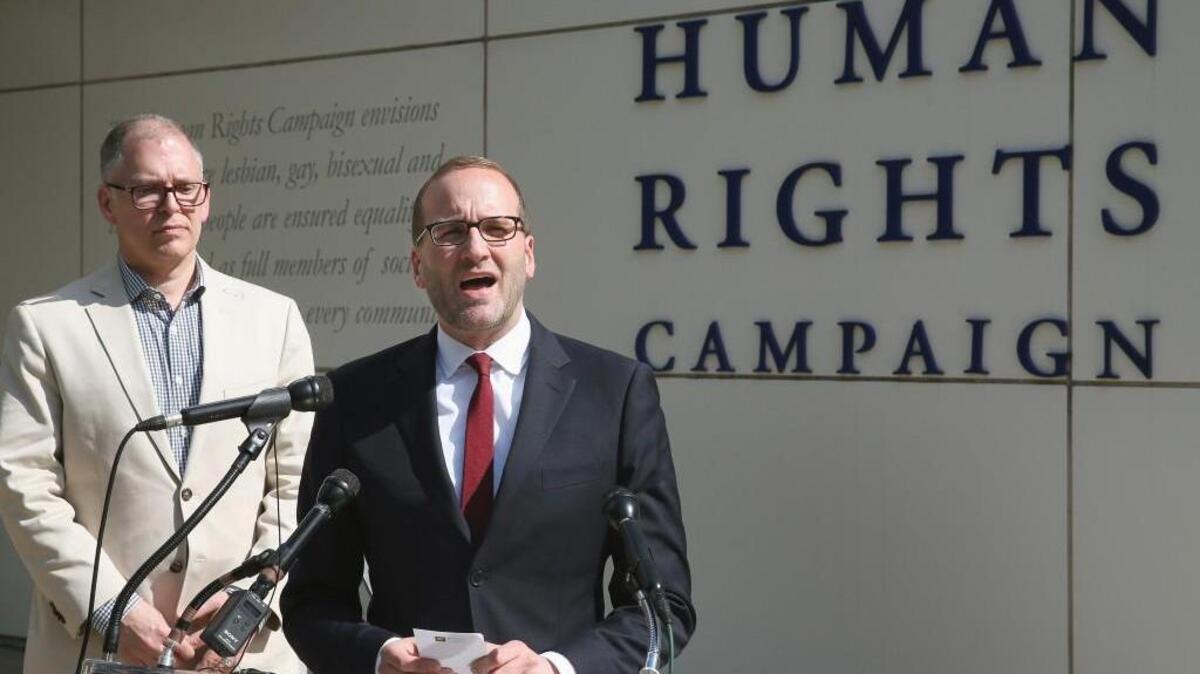 Human Rights Campaign President Chad Griffin (R) speaks about Plaintiff's James Obergefell (L) case before arguments at the US Supreme Court April 27, 2015 in Washington, DC. The high court is scheduled to hear arguments in the case of Obergefell v. Hodges, that will ultimately decide whether states will still be allowed to ban same sex marriage and refuse to recognize the rights of couples married in other states.