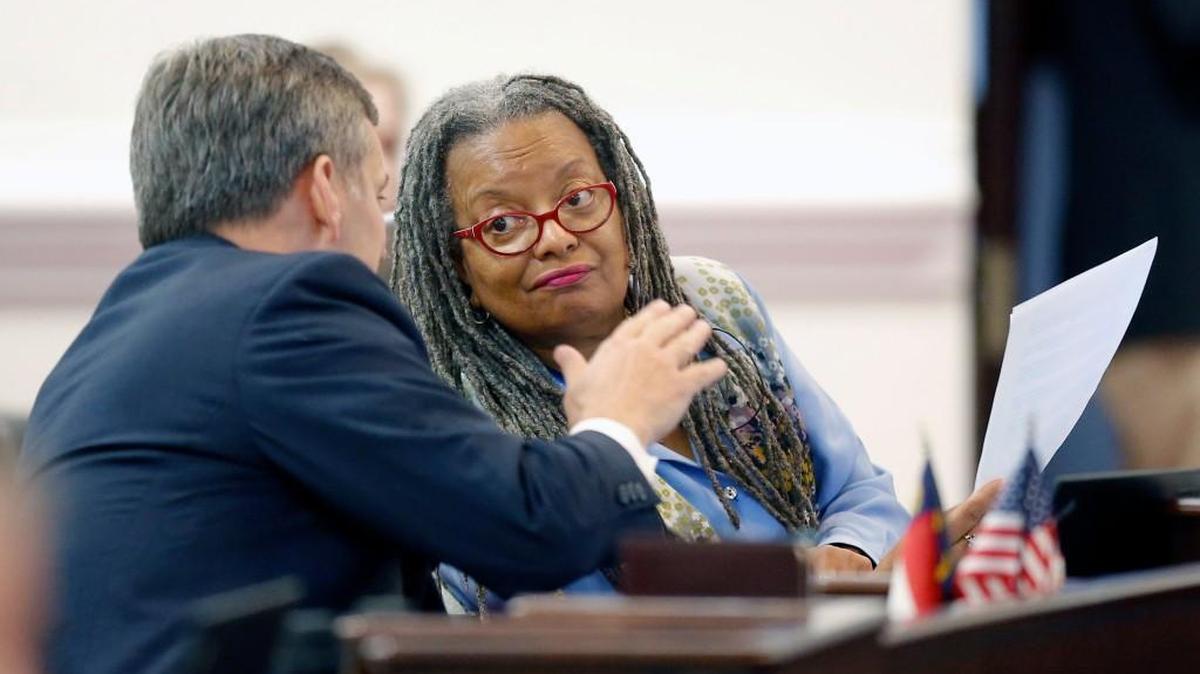 Sen. Angela Bryant confers with then-state Sen. Josh Stein on the floor in the Senate chambers in Raleigh in 2015. Bryant announced Monday she won’t seek re-election.