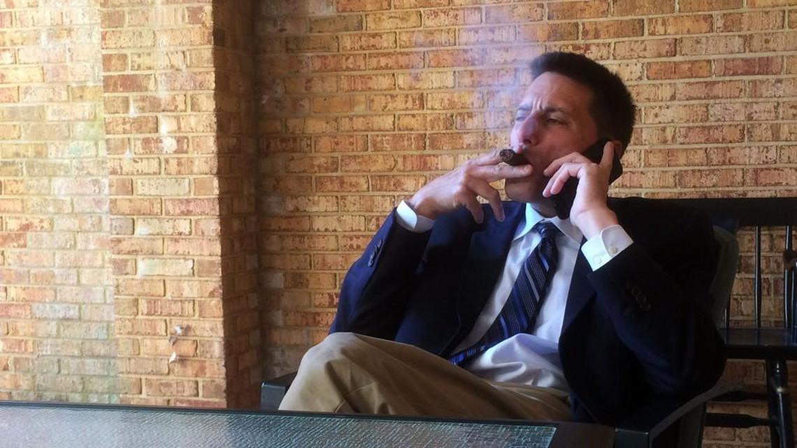 Dallas Woodhouse, executive director of the North Carolina Republican Party, takes a smoke break outside his office while checking in with party officials. "Everybody's got to have a vice," he says, and smoking is his.