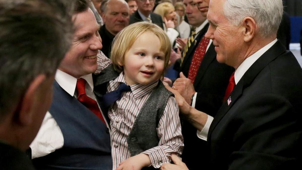 Vice President Mike Pence acknowledges a young child along the rope line after speaking at the America First Policies, "Tax Cuts to Put America First" event Thursday, March 22, 2018, in Manchester, N.H. (AP Photo/Mary Schwalm)