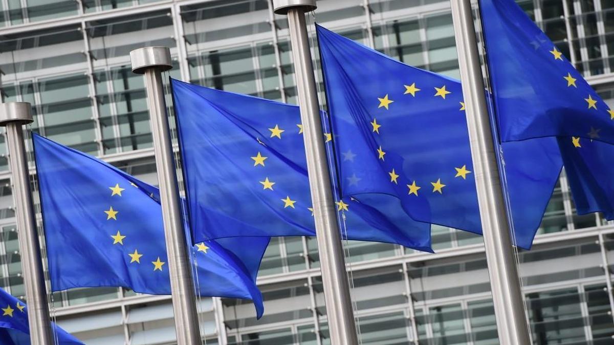 European flags flutter in front of the European Commission building.