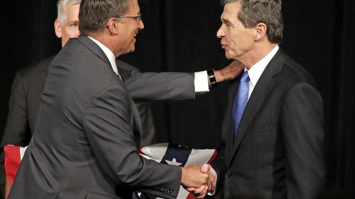 North Carolina Gov. Pat McCrory, left, shakes hands with North Carolina Attorney General Roy Cooper after a debate in Charlotte in June.