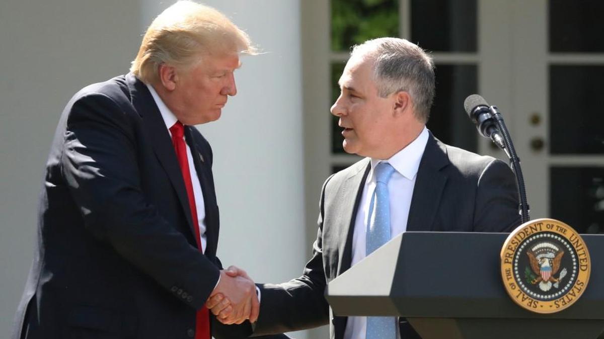 In this June 1, 2017 file photo, President Donald Trump shakes hands with EPA Administrator Scott Pruitt. Before he left the agency, Pruitt changed rules that protected the public.