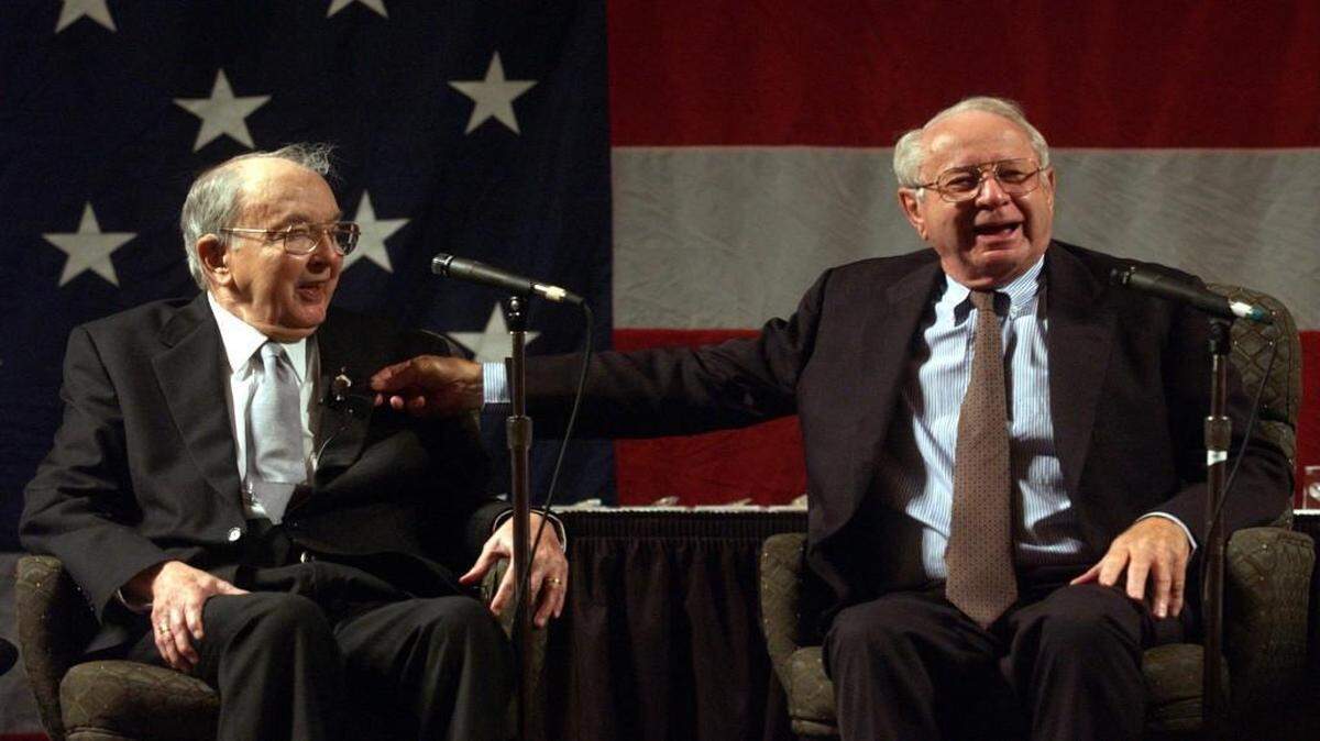 Lauch Faircloth, right, pinches the suit of Jesse Helms, left, while telling a story to those in attendance at the North Carolina Republican Party’s 2003 Hall Of Fame Banquet at the Embassy Suites hotel in Cary.