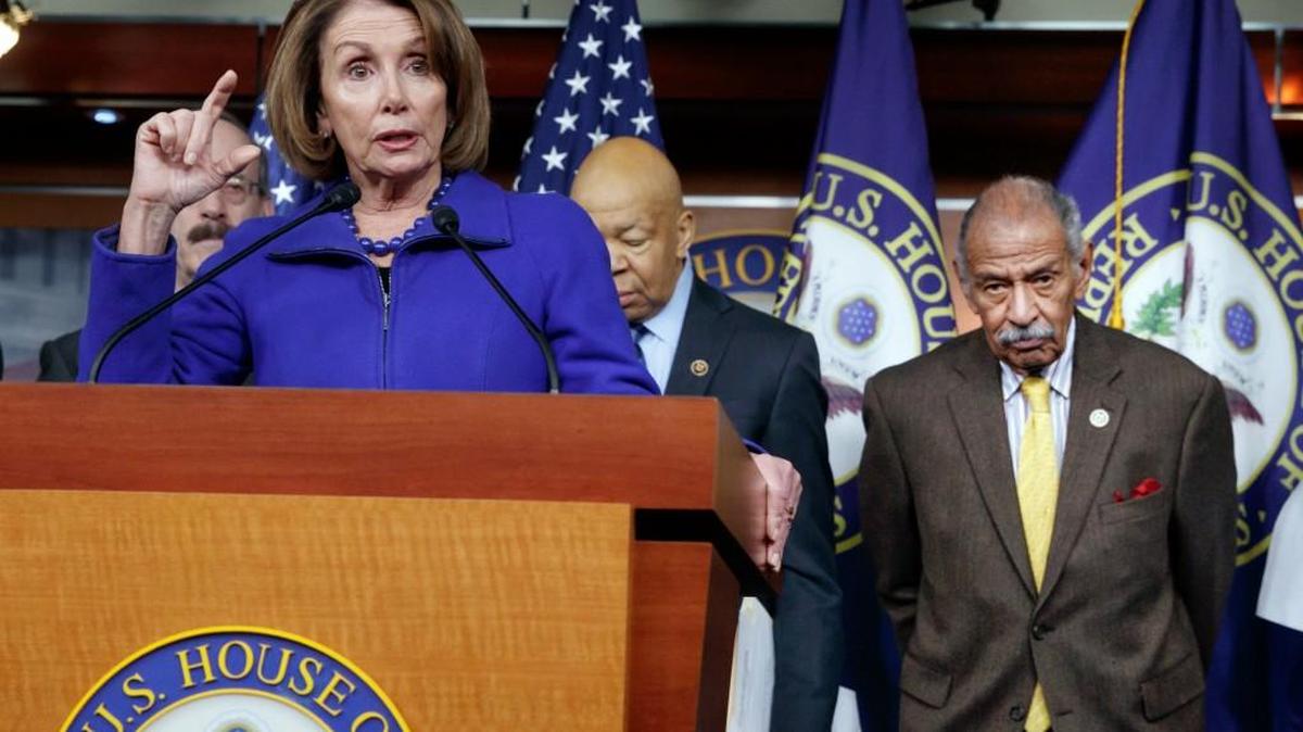 In this file photo from Feb. 14, 2017, House Minority Leader Nancy Pelosi, D-Calif., Rep. John Conyers, D-Mich., right, and other top House Democrats, at a news conference on Capitol Hill in Washington. Pelosi said today, Thursday, Nov. 30, 2017, that Conyers should resign, saying the accusations are "very credible."