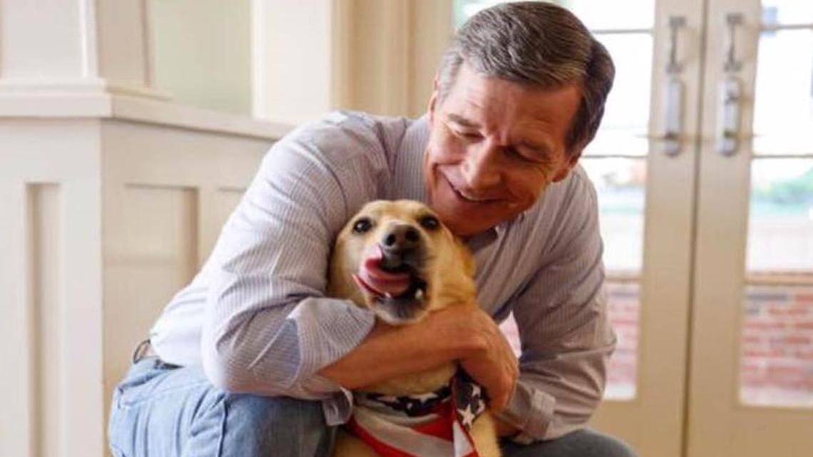 Gov. Roy Cooper with his “grand-dog” Ben, who enjoys “sitting on his loved one's feet and licking himself,” according to a Facebook page created for the governor’s pets.