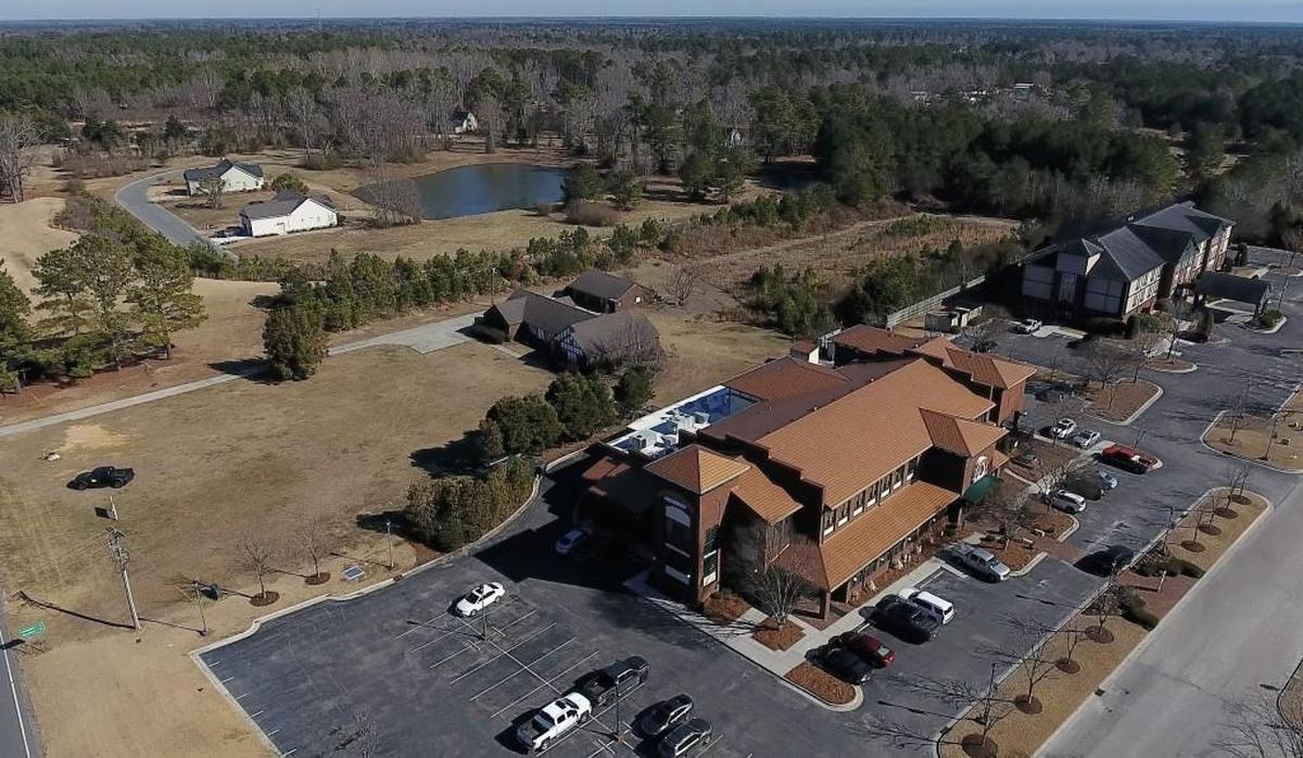The River Landing community sits behind the Boars Head restaurant and Holiday Inn Expess which are all owned by the Wendell Murphy family. Rep. Jimmy Dixon stuck $830,000 quietly into the state budget last spring to build a new sewer line and upgrade a sewer pump station in Wallace, NC, at the River Landing gated community which will allow Wendell Murphy's family to expand the Holiday Inn Express and also allow more homes to be built at River Landing, the upscale subdivision Murphy built 20 years ago for the executives of his pork company.