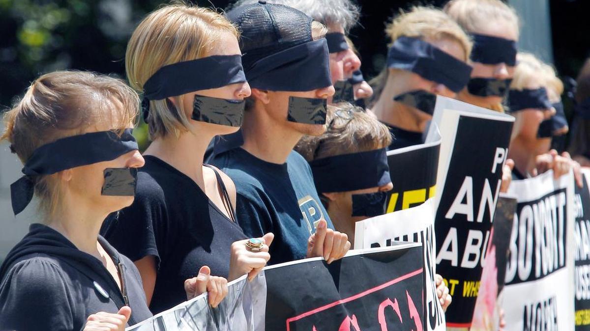 About fifty protestors don blindfolds and gags as they gather at the N.C. Capitol in Raleigh to protest an Ag-Gag bill that would make it more difficult to report cases of animal mistreatment in this May 27, 2015, file photo.