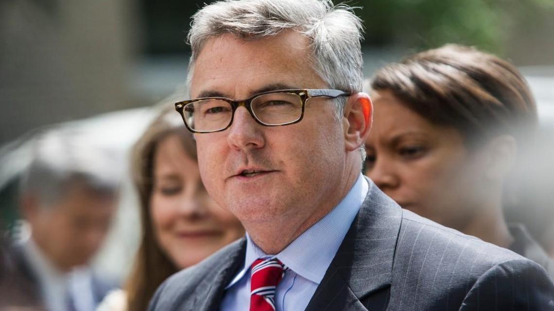 Thomas Walker, United States Attorney for the Eastern District of North Carolina, center prepares to talk with reporters outside federal court May 14, 2015 in Greenville. Walker announced his resignation Tuesday, effective Jan. 7.