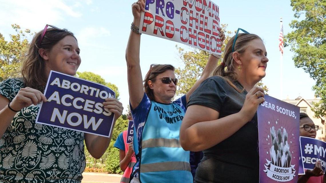Jen Ferris, Susan Stancill and Kelsey McLain (left to right) celebrate the Supreme Court decision today which overturned a Texas law that was blamed for the closing of 3 out of 4 abortion clinics in the state. The small rally with less than 20 supporters was held across the street from the Governor's mansion in Raleigh, N.C., Monday, June 27, 2016.