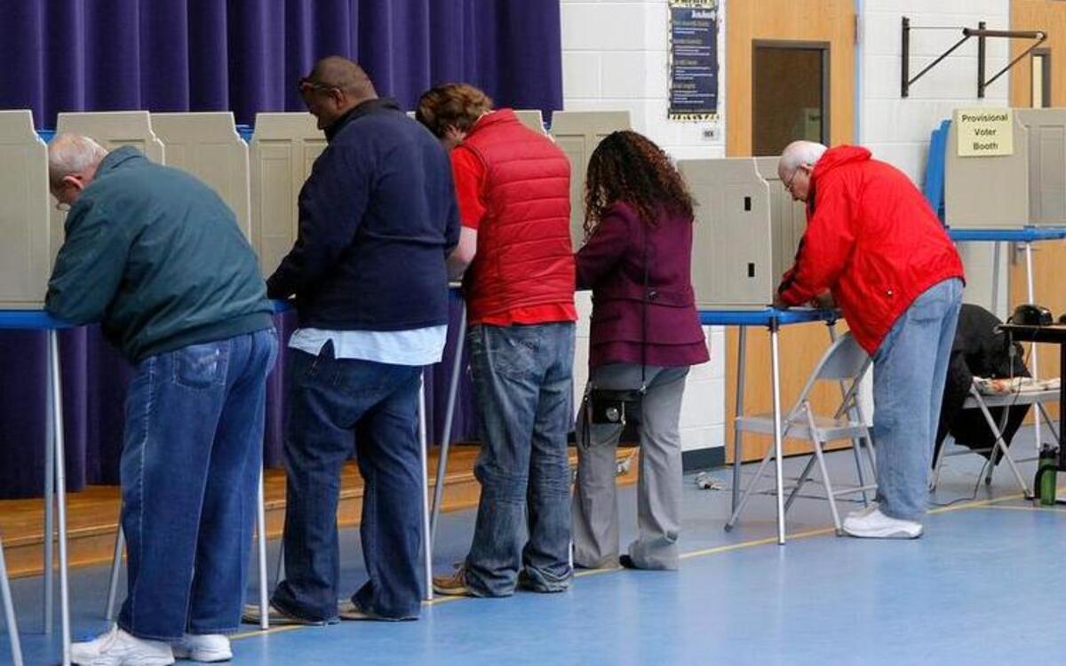 
Voters cast their ballots at the stations, left, while poll workers process voters, right, at Precinct 01-44, Millbrook Elementary School, in Raleigh on Nov. 5, 2014.
