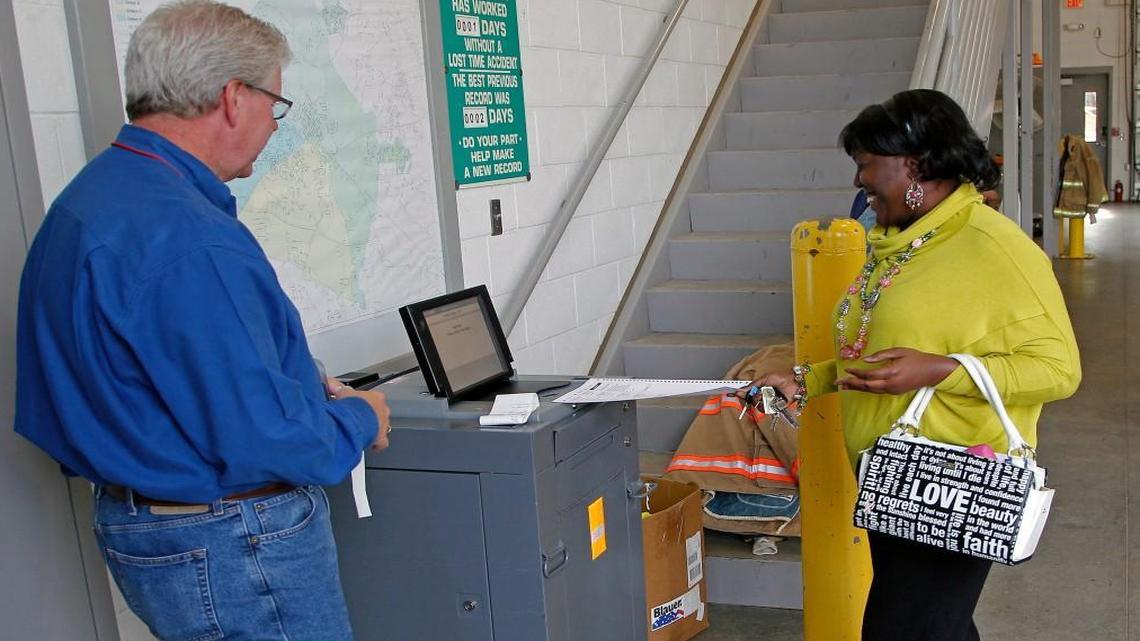 
Poll worker Robert Capps, left, watches as Cynthia Toudle, right, inserts her ballot in the voting machine at Johnston Co. House and Senate leaders say they’ve agreed to put a bond package before voters sometime next year.
