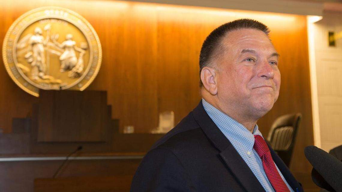 Rep. Paul "Skip" Stam, R-Wake, speaks with reporters at 4:25 a.m. Wednesday on the floor of the N.C. House following his announcement that he would not seek re-election in 2016.