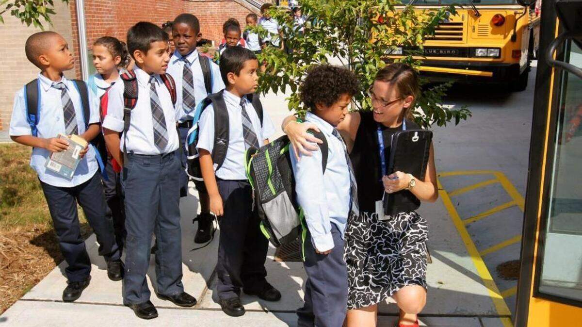 Maureen Joy Charter School 2nd grade teacher Caitlin Trapani, right, made sure she hugged or gave a personal goodbye to each of her 2nd graders before they got on the bus Wednesday afternoon, Sept. 4, 2013.