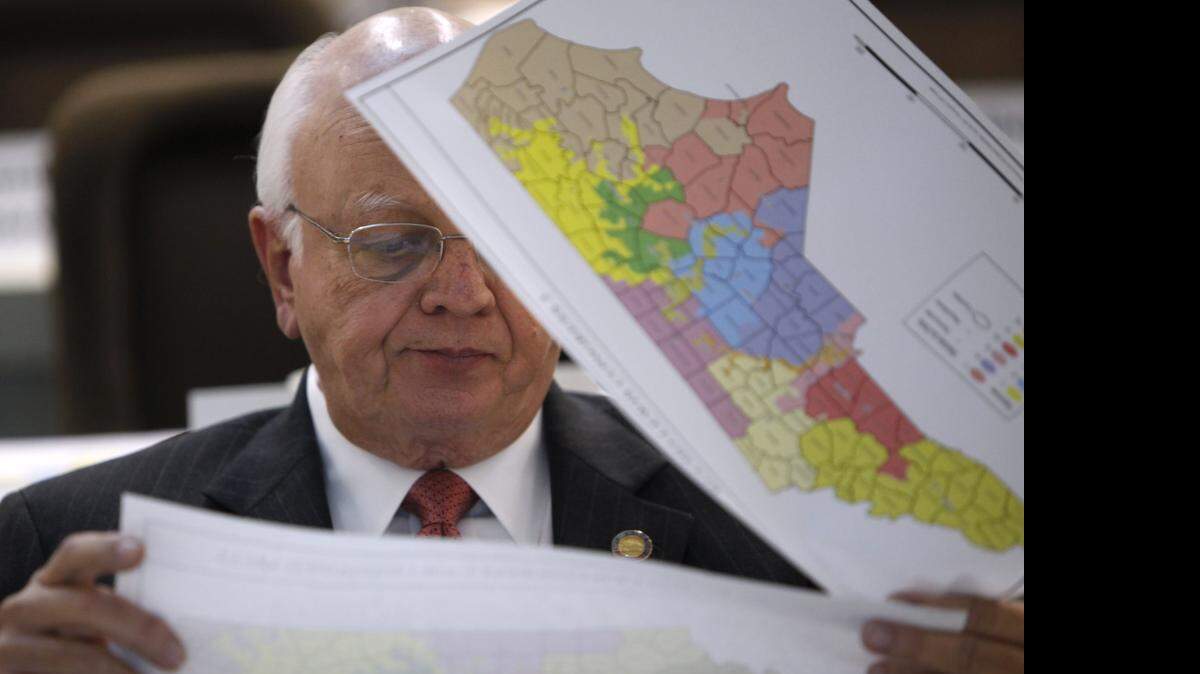 Rep. John Faircloth checks maps during a meeting of joint redistricting committees Monday, Nov. 7, 2011.