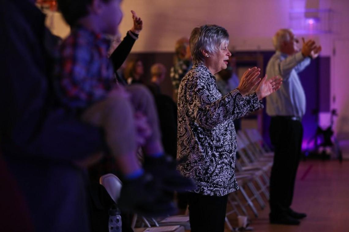 Debbie Moss sings along during a church service on Sunday Nov. 12, 2017 at New Path Church which is located in Hilburn Academy's gym.