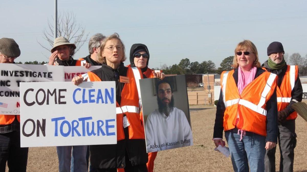 Christine Cowger, front-left, and Allyson Caison, front-right, in front of Aero Contractors, a company based in Johnston County, in 2013 were trying to raise awareness of rendition flights and the torture of terrorism suspects.