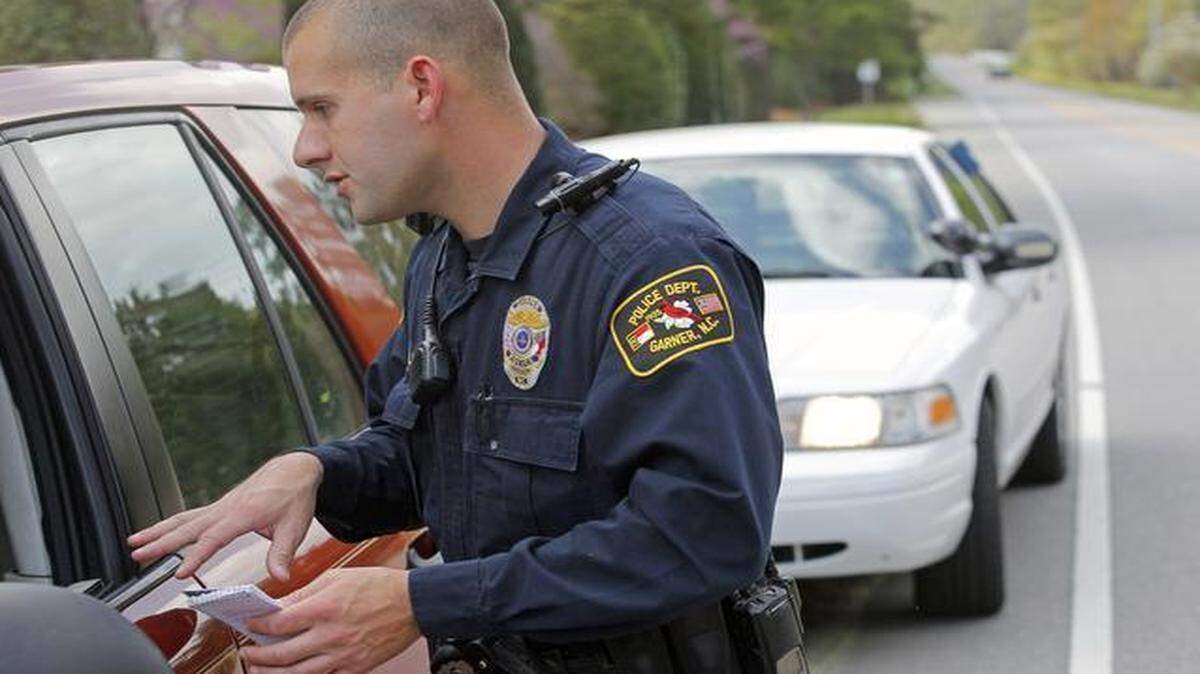 
A body camera on his left shoulder records Garner police officer Kevin Murray's interaction with a motorist as he makes a traffic stop on his patrol in Garner on Wednesday. He is testing the camera for the Garner Police Department. A bill currently being considered in the General Assembly would require all major NC law enforcement agencies to equip their officers with body-worn cameras.
