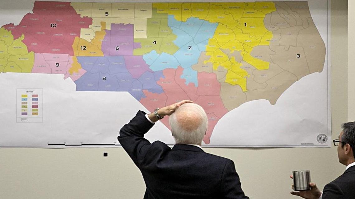 Joint Select Committee on Congressional Redistricting members review historical voting maps lining the walls during their morning meeting at the N.C. Legislature on Tuesday.