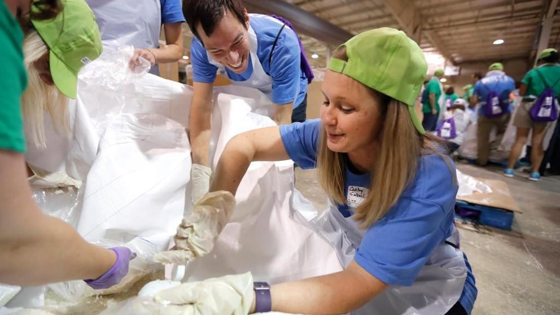 Dan Segal, left, and Cathy Sabodish, both with RTI International, help pack rice into family sized bags during the Food Bank of Central and Eastern North Carolina's Sort-A-Rama at the Graham Building at the N.C. State Fairgrounds on May 25, 2017. Over 1,000 volunteers converged on the Fairgrounds to pack more than 190,000 meals for needy families.