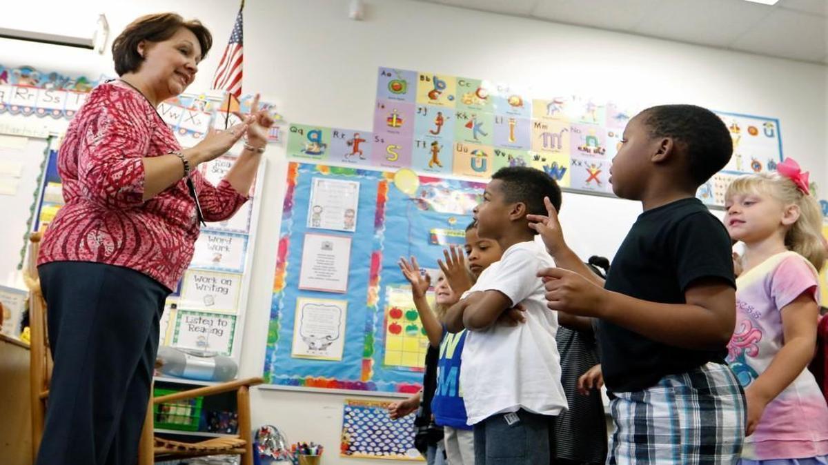 From left, River Bend Elementary kindergarten teacher Valerie Minervini leads her students in a morning counting song during their Sept. 15, 2016 school day. The General Assembly is considering legislation to ease the impact of new state-mandated class size reductions in kindergarten through third-grade classes.