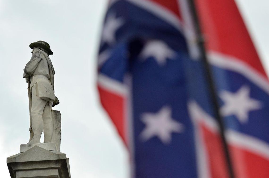 A statue of a Confederate soldier stands atop an obelisk in front of the Gaston County courthouse in Gastonia, NC. 