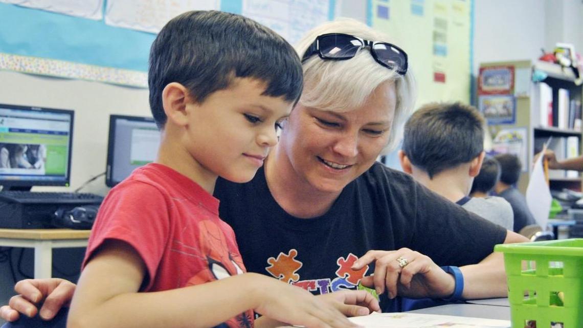 Teacher assistant Aimee Pattison, right, helps first-grader Jaeden Clayton-Valdez with reading exercises at Lake Myra Elementary in Wendell in June 2015.