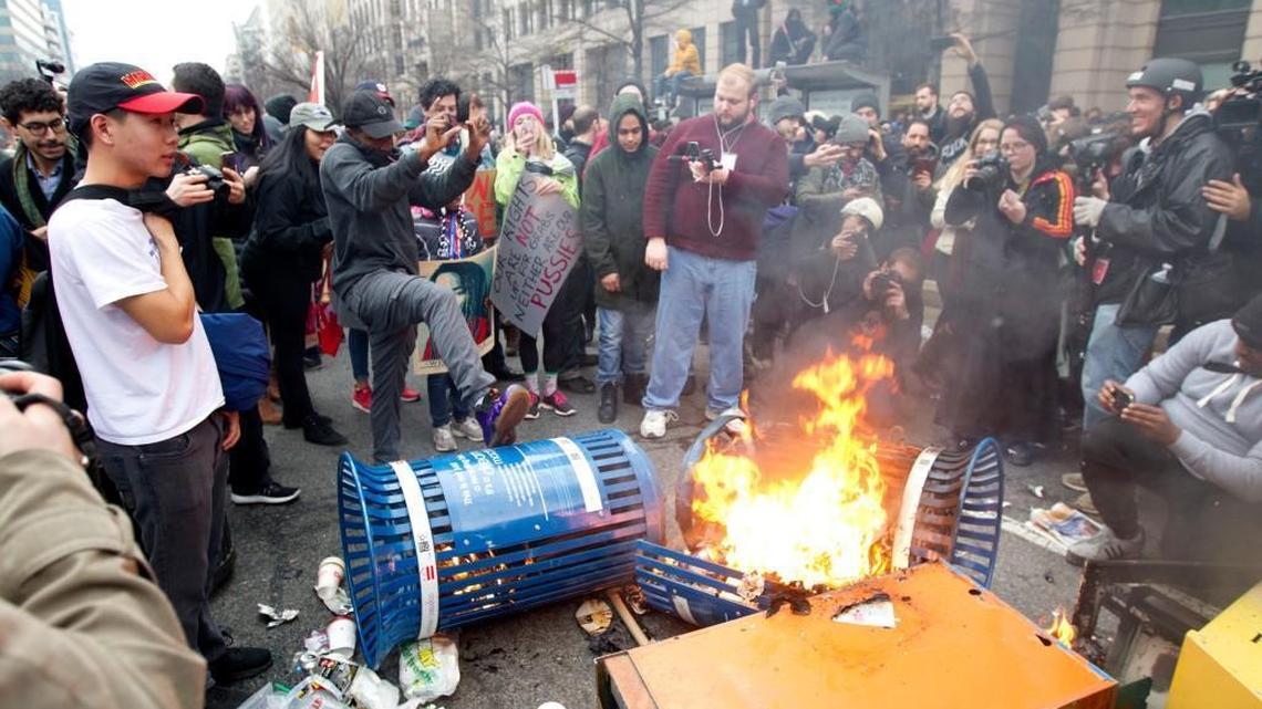 Protesters burn trash cans during the demonstration downtown Washington, Friday, Jan. 20, 2017, during the inauguration of President Donald Trump.