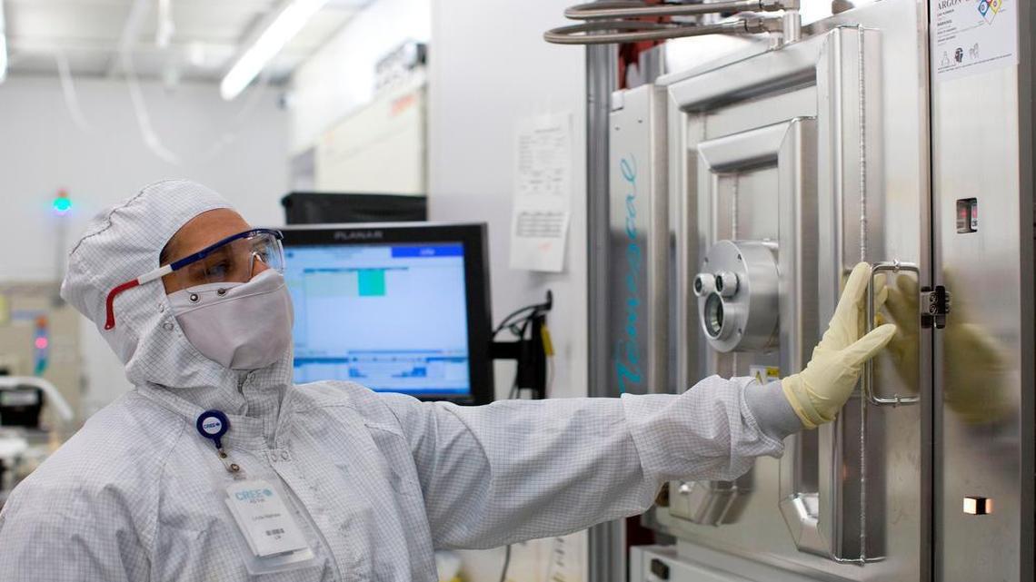 Semiconductor Operator Linda Mathew tends to wafers inside of an evaporator machine inside of Cree’s “clean room” environment on Friday, August 15, 2014 in Research Triangle Park.
