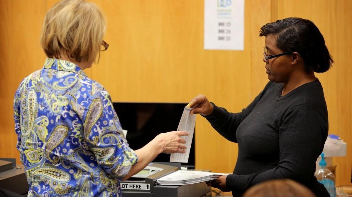 Paid volunteers process ballots during the second day of a Durham County vote recount at the Durham County Board of Elections on Sunday, Dec. 4, 2016.