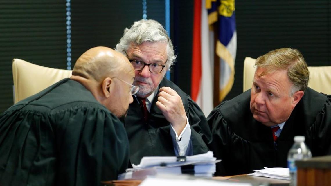 A three judge panel of L. Todd Burke, left, Jesse B. Caldwell, center and Jeffery B. Foster confer earlier this year in a case where Gov. Roy Cooper challenged a General Assembly bill.