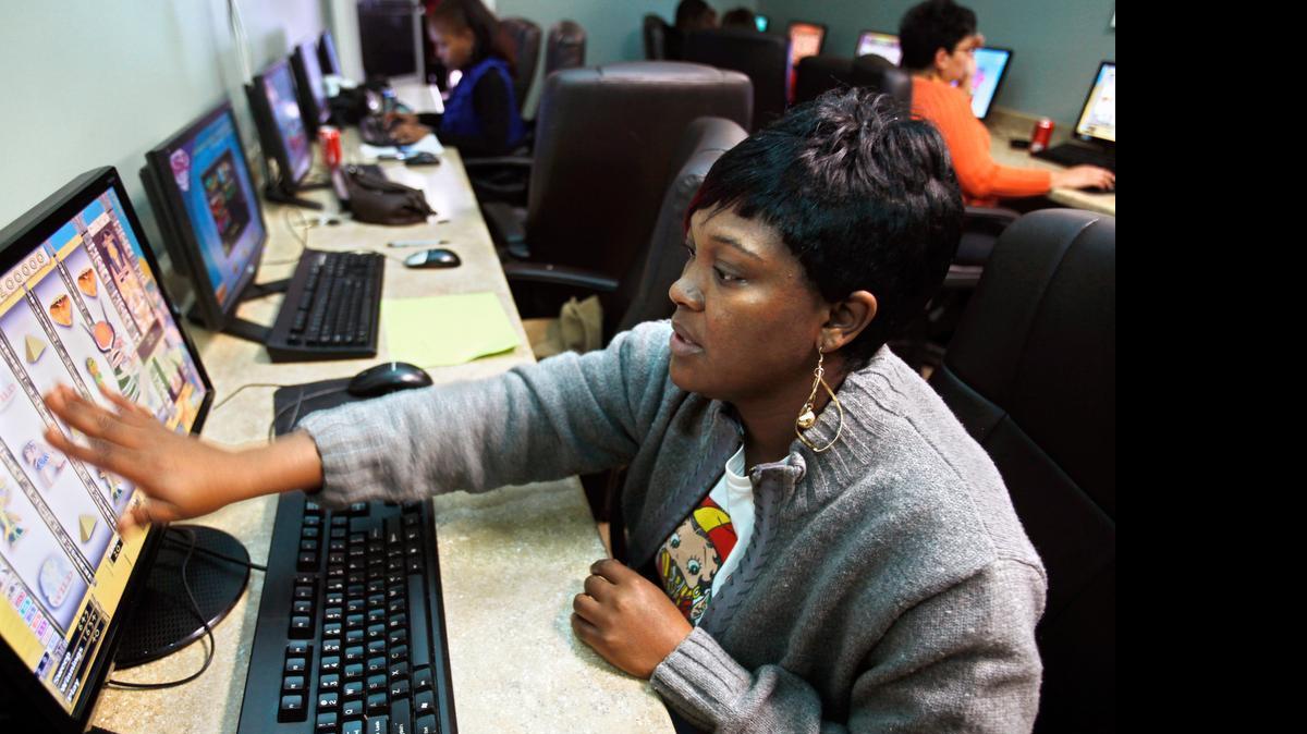 
Crystal Bryant of Lillington rubs the screen for good luck at an Internet sweepstakes parlor in Fuquay-Varina in 2010. 
